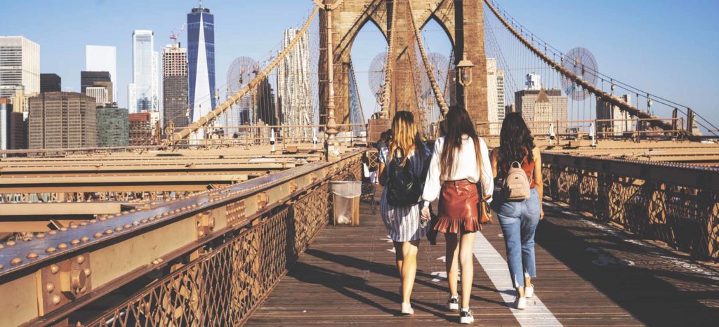 What to pack in a day bag, girls walking over the Brooklyn Bridge