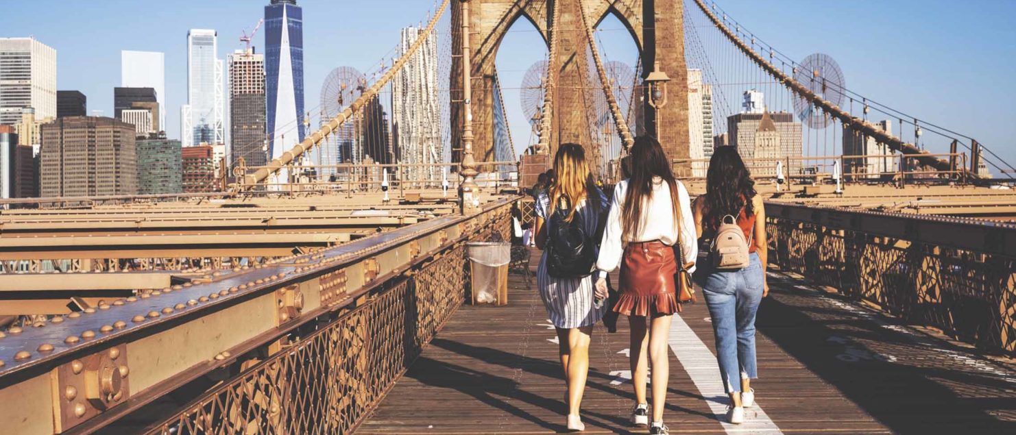 What to pack in a day bag, girls walking over the Brooklyn Bridge