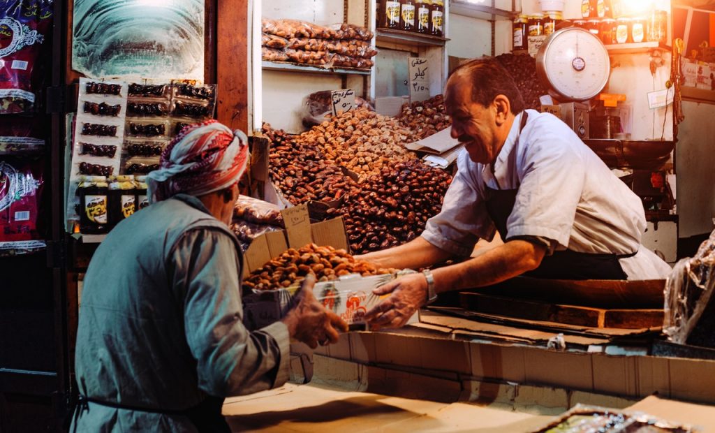 bartering, 2 men selling in a market