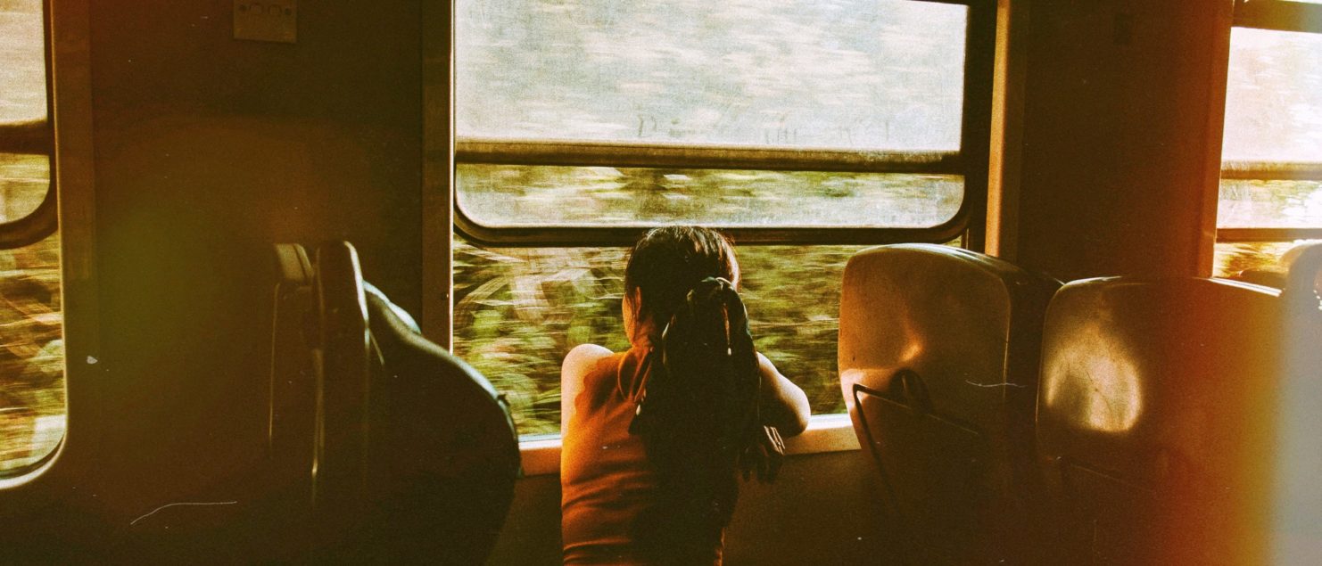 train trip woman on train looking outside window