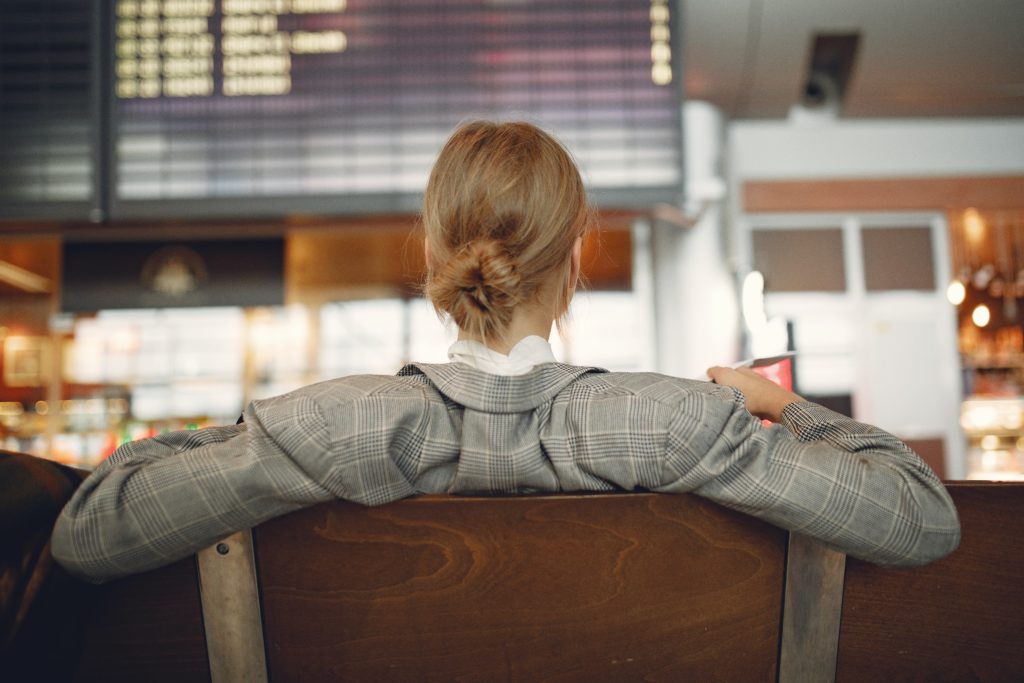 How Airport Lounges Work Woman Sitting In Airports Departures