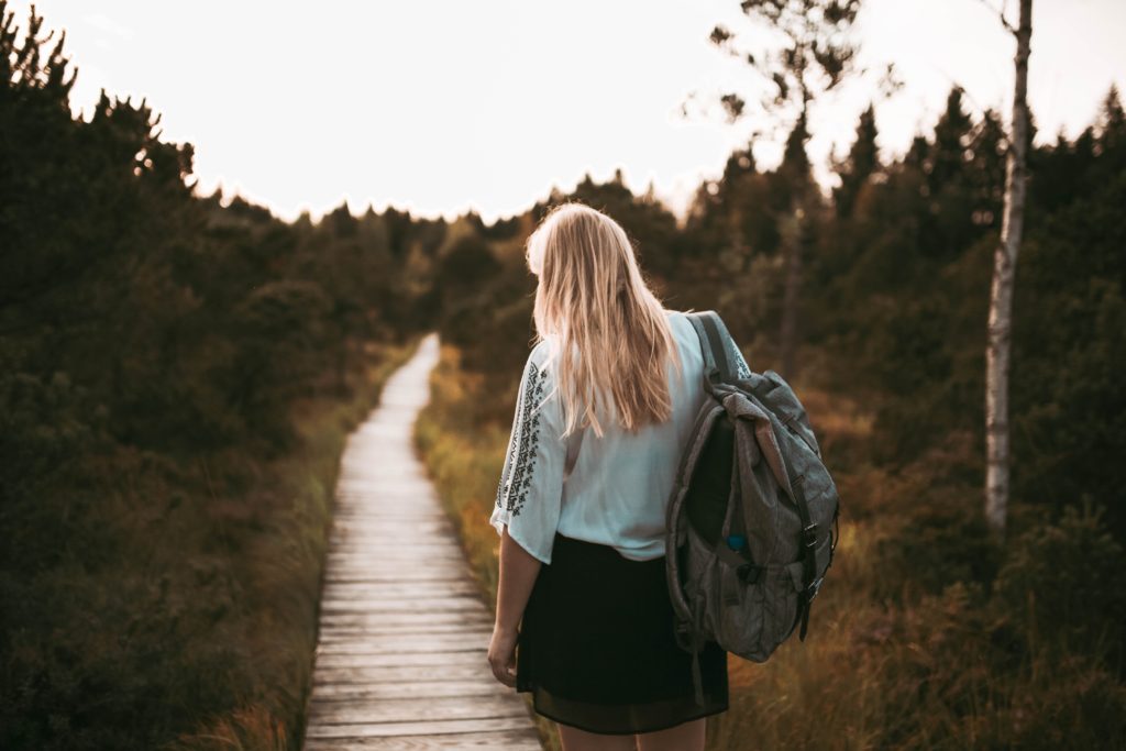 packing woman walking through footpath