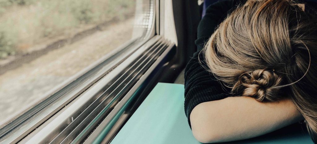 travel decision fatigue, stressed woman on a train