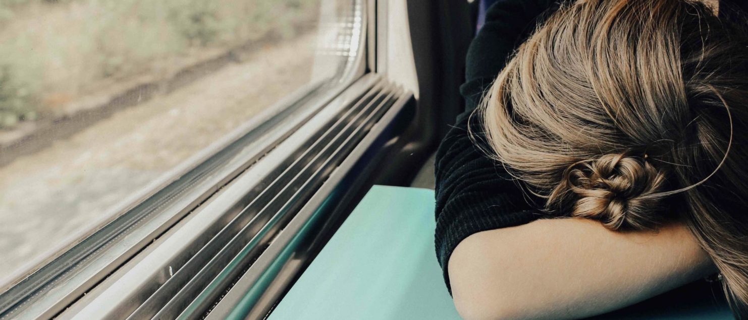 travel decision fatigue, stressed woman on a train